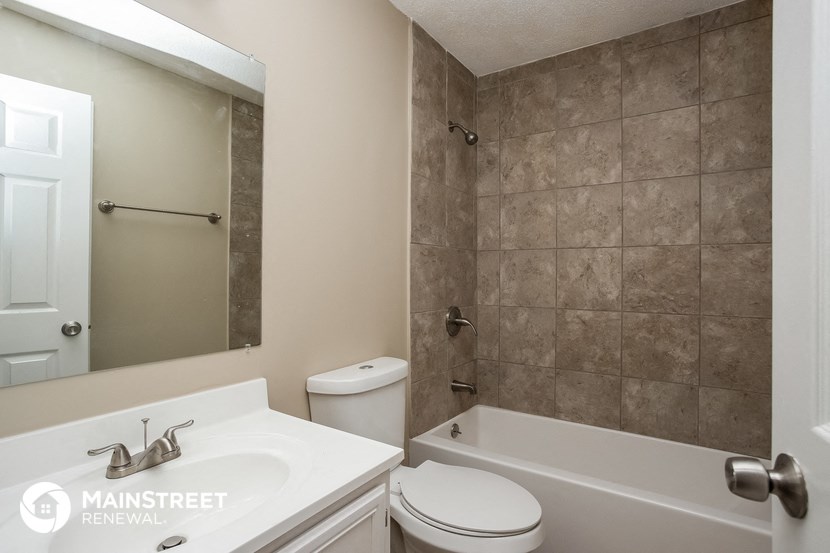 a bathroom with a sink toilet and a bath tub