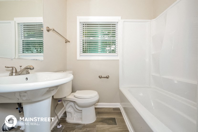 a bathroom with a sink toilet and a bath tub