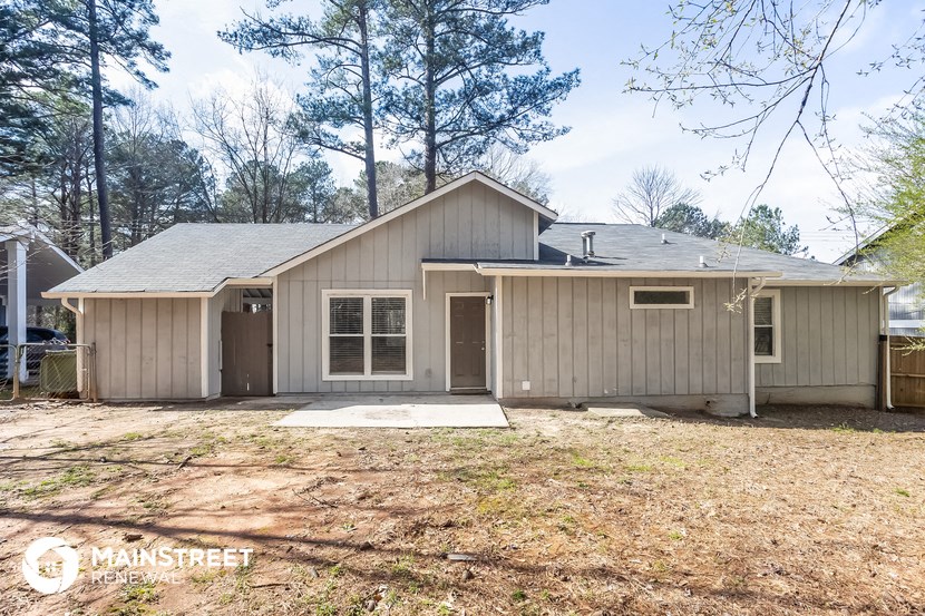 the front of a house with a yard and a garage