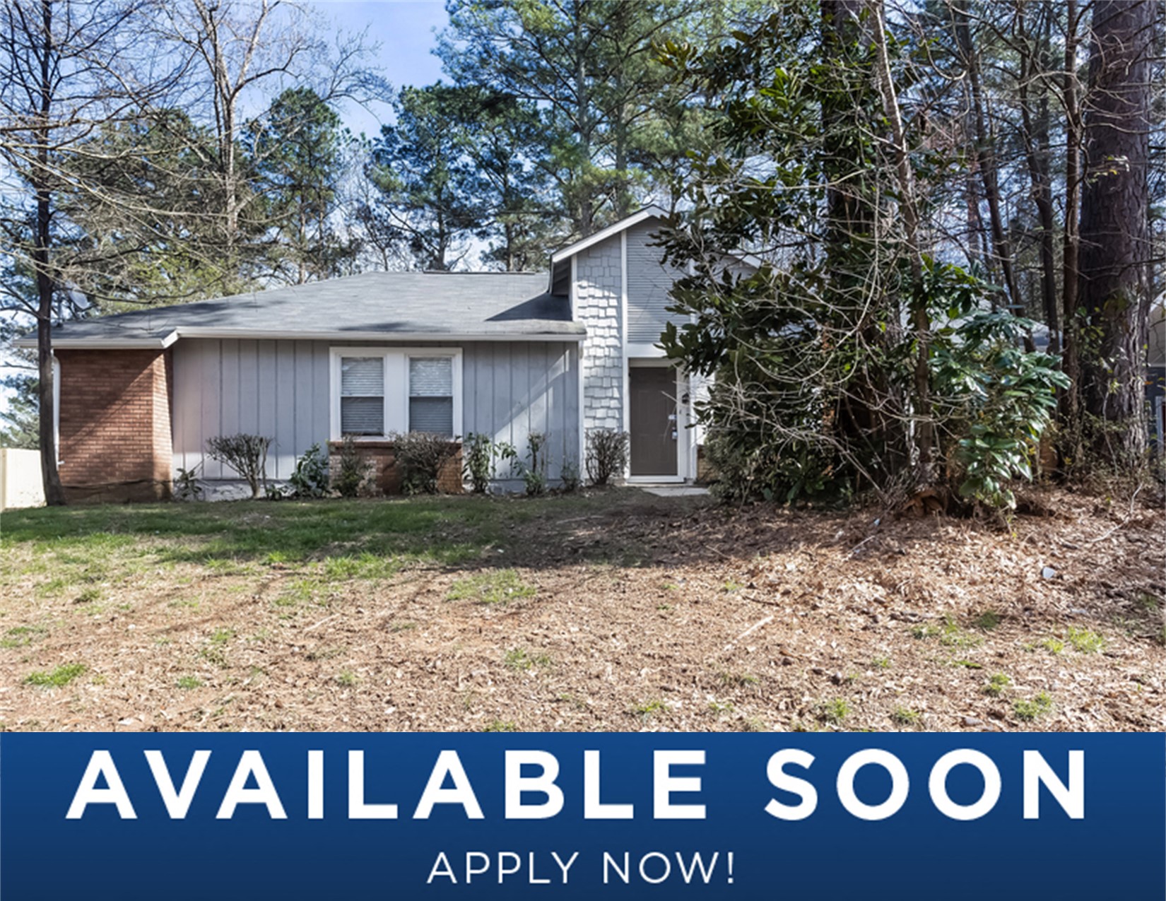 a small white house with a yard and trees