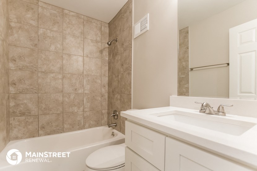 a bathroom with a sink toilet and shower and a bath tub