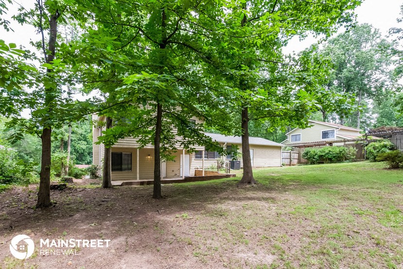 a small house with trees in front of it