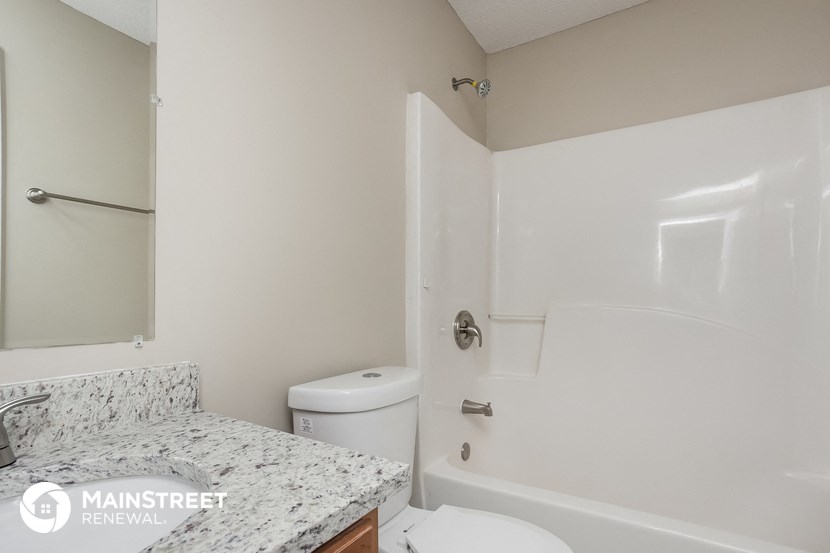 a bathroom with a sink and a toilet and a shower