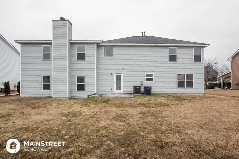 a white house with a yard in front of it