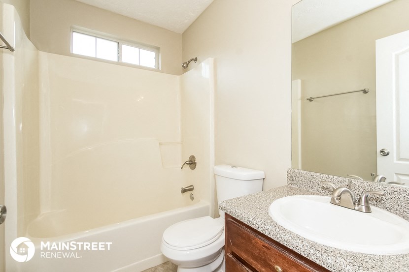 a bathroom with a sink and a toilet and a shower
