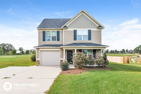 a suburban home with a lawn and a green yard