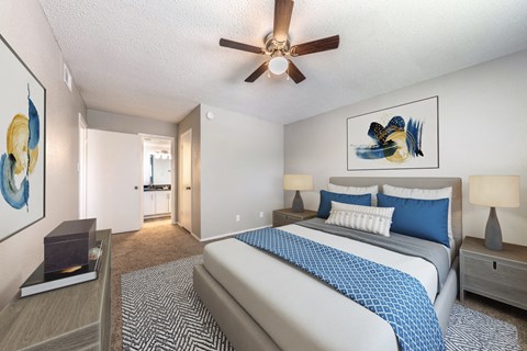 a bedroom with a bed and a ceiling fan