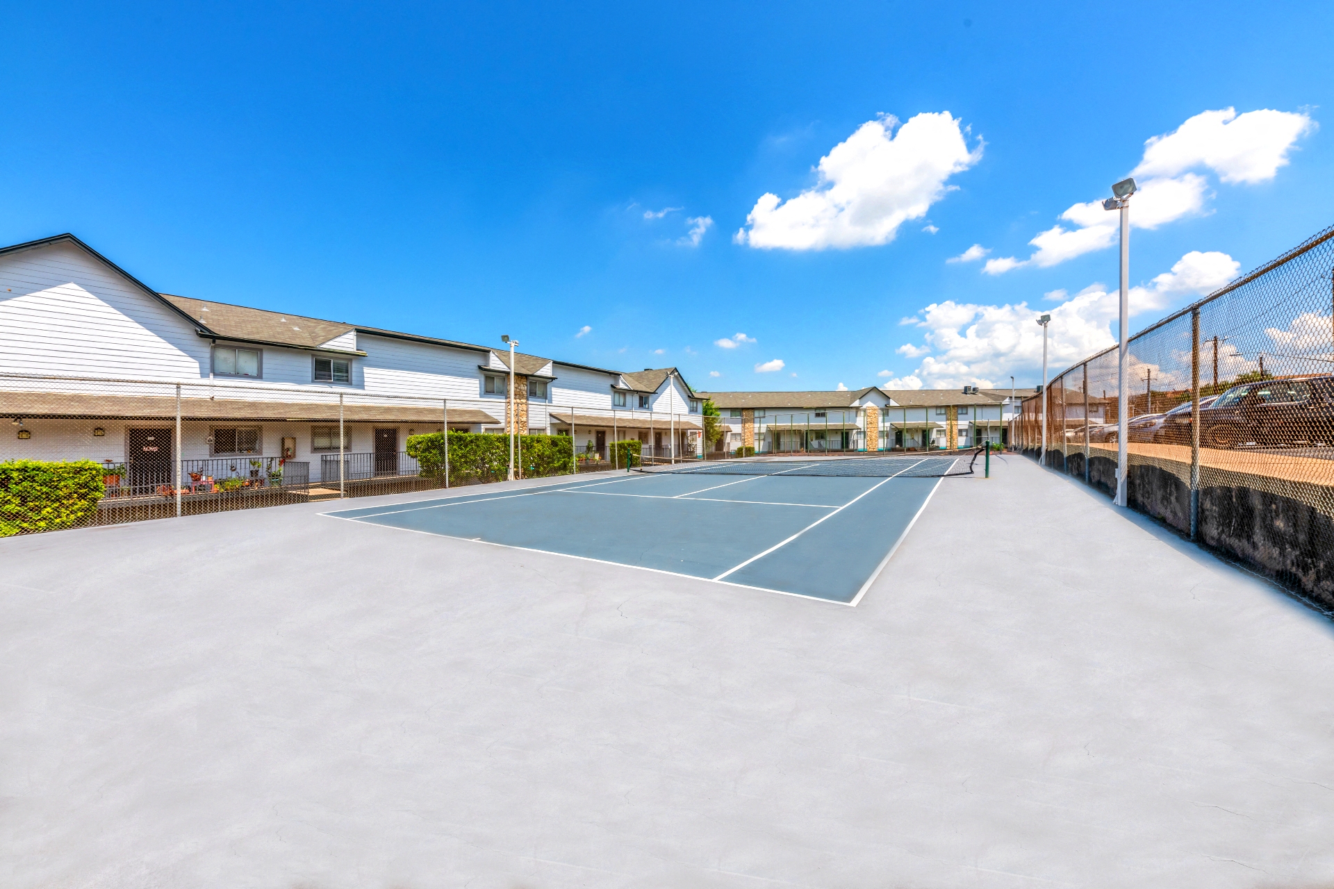 a tennis court at the whisper greens apartments