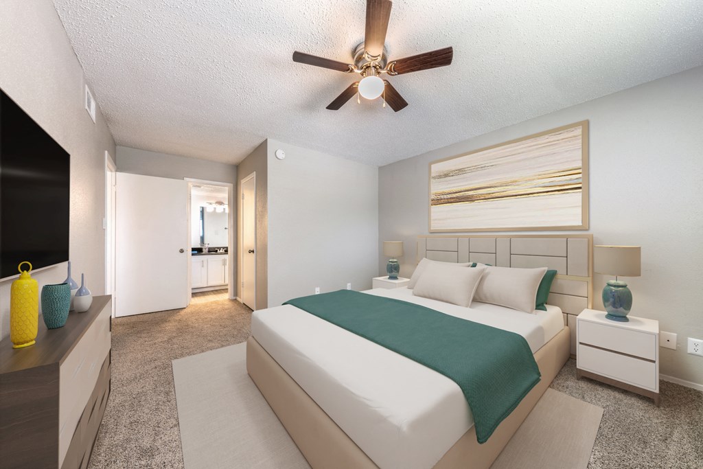 A bedroom with a large bed and a ceiling fan. at Alister Apartments, Austin, Texas