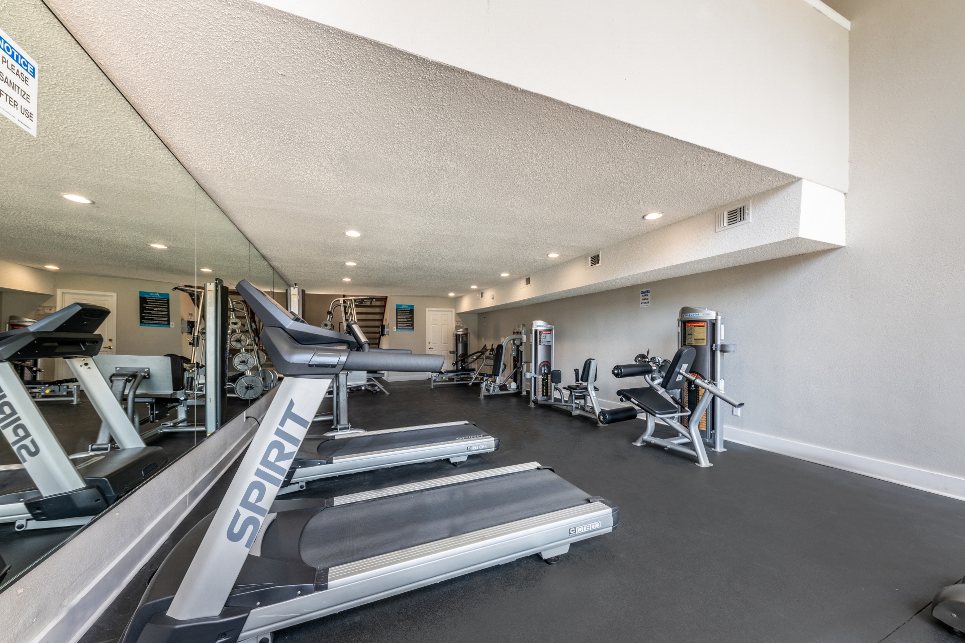the gym with treadmills and other exercise equipment at the belgard apartments