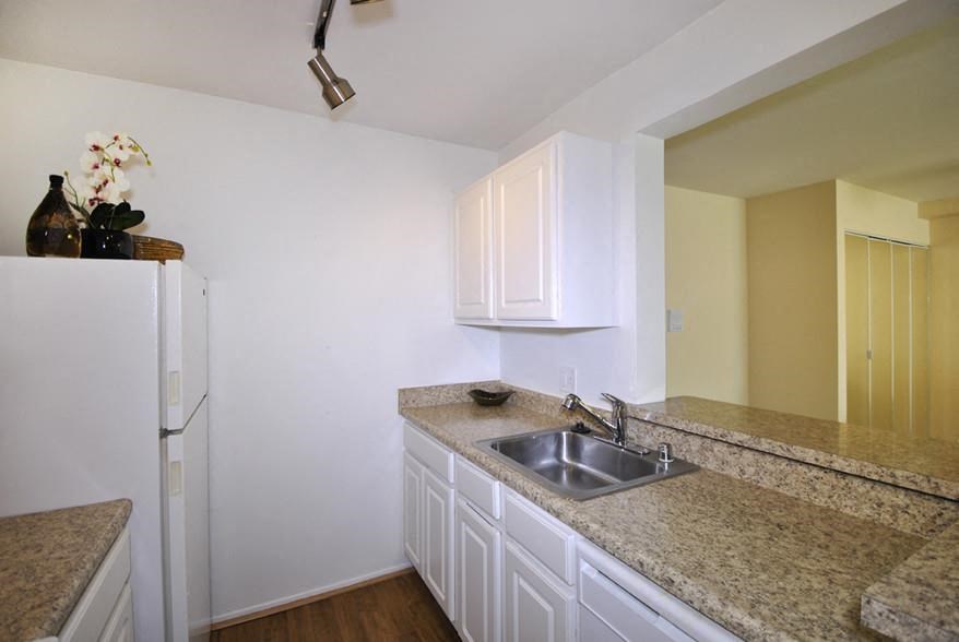 a kitchen with a sink and a refrigerator