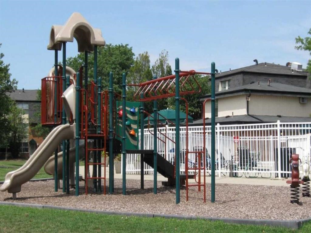 a playground with a slide and other play equipment in a park