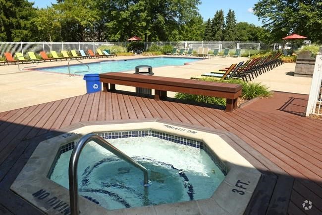 a jacuzzi in a hot tub next to a swimming pool