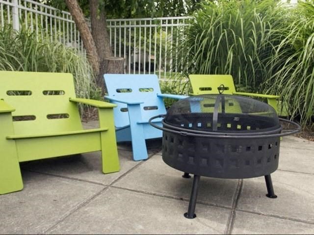 a group of chairs sitting around a fire pit