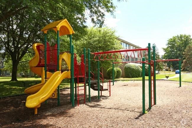 a playground with a slide and other toys in a park