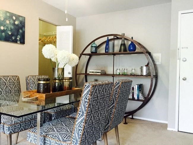 a dining room with a glass table and chairs