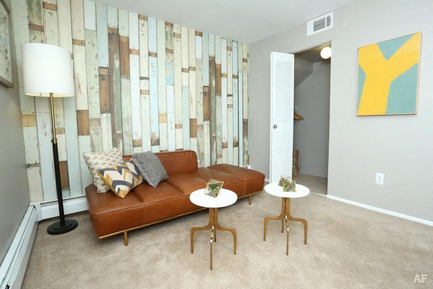 a living room with a couch and two tables