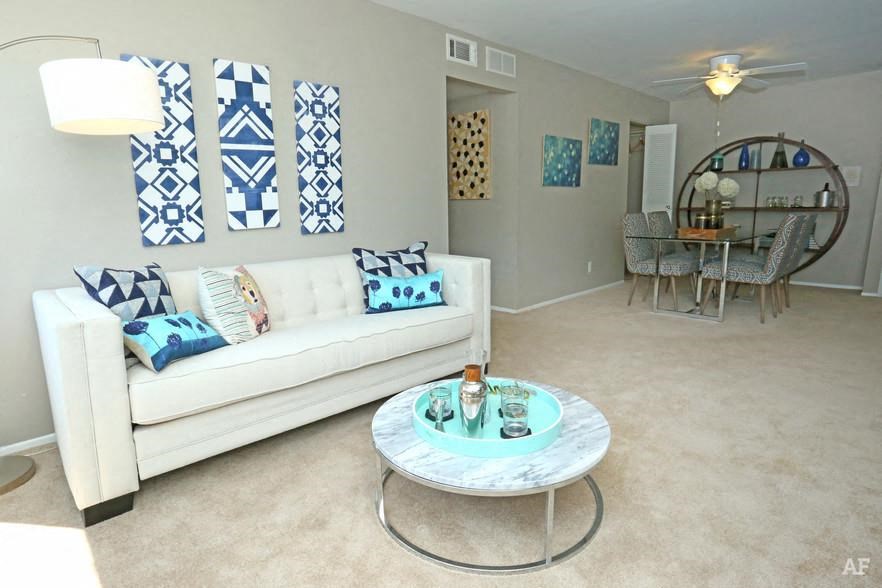 a living room with a white couch and a table