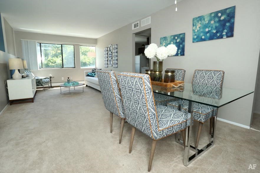 a dining room with a glass table and chairs