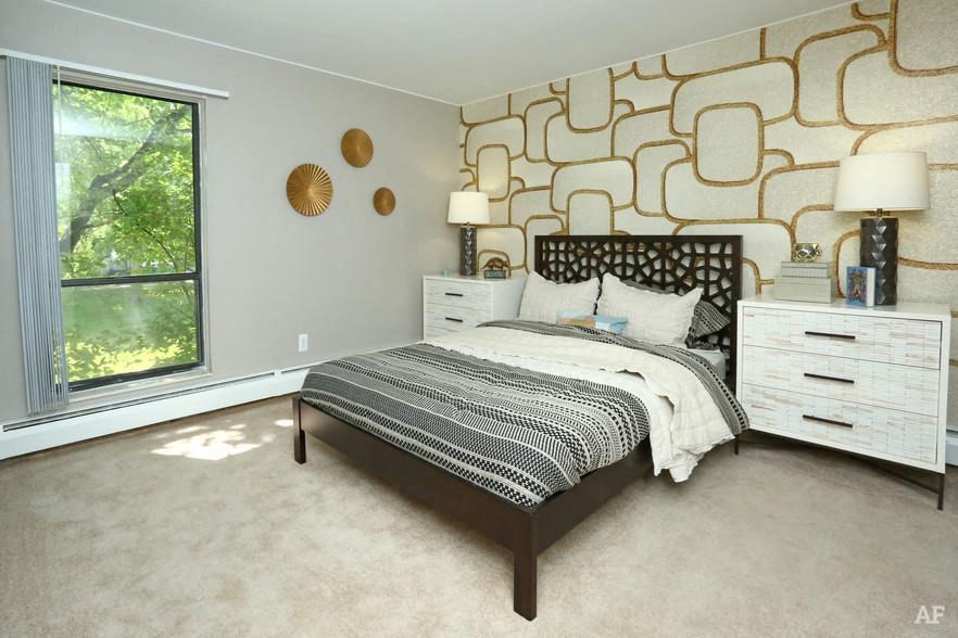 a bedroom with a bed and two dressers