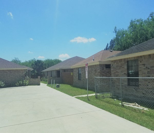 a chain link fence in front of some houses