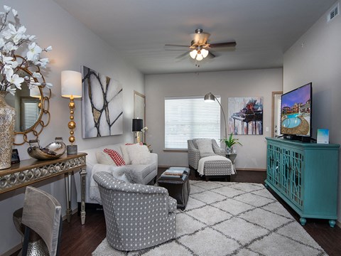a living room with furniture and a ceiling fan