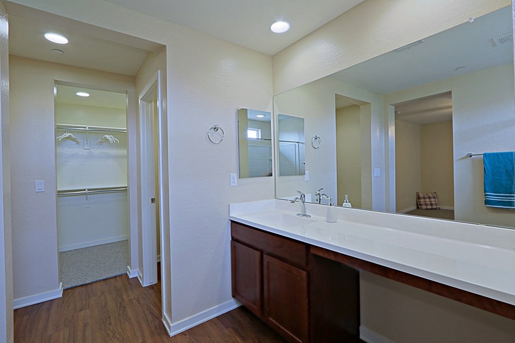 a bathroom with a large mirror and a large sink