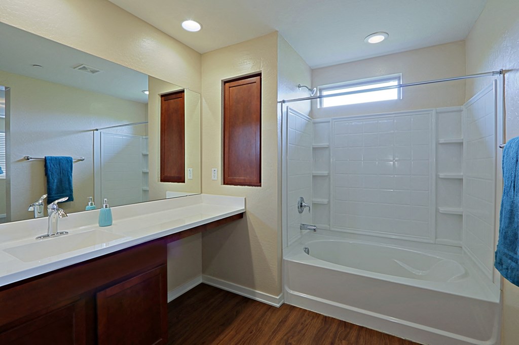 a bathroom with a shower and a sink and a mirror