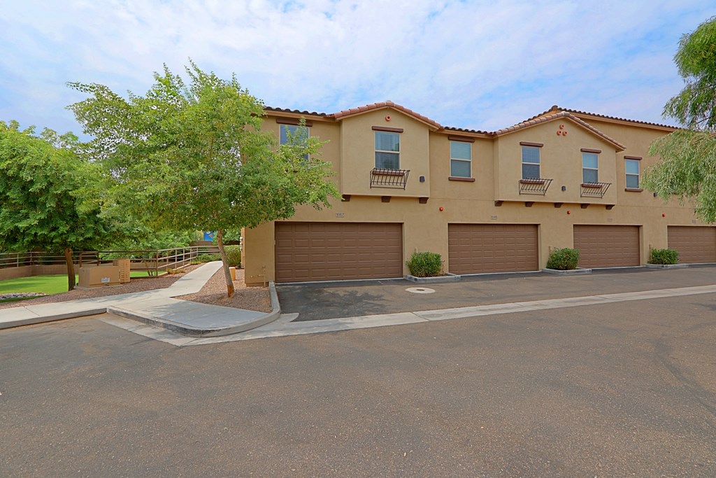 a house with three garage doors on a street