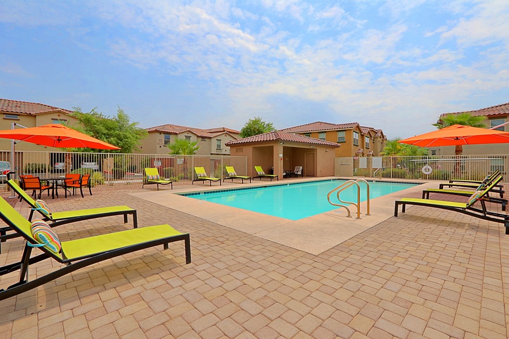 our apartments have a swimming pool with chairs and umbrellas