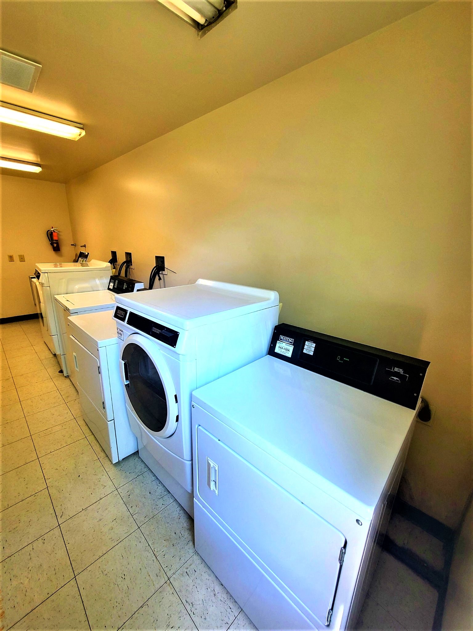 a row of washing machines in a laundry room