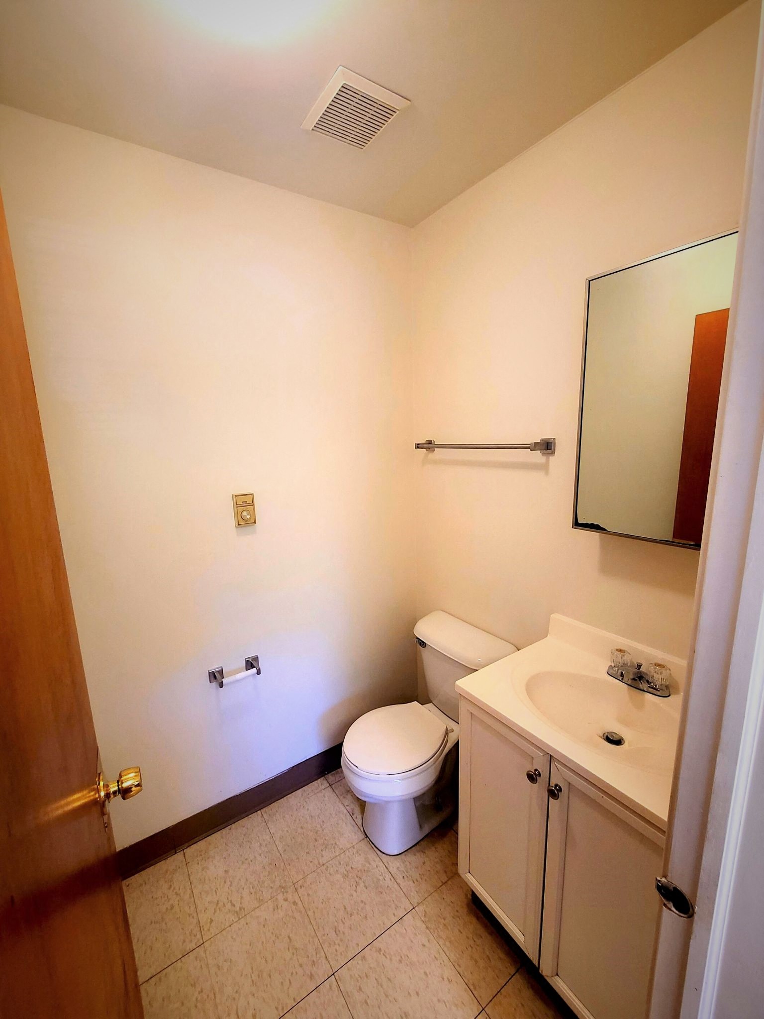 a bathroom with a toilet and a sink and a mirror