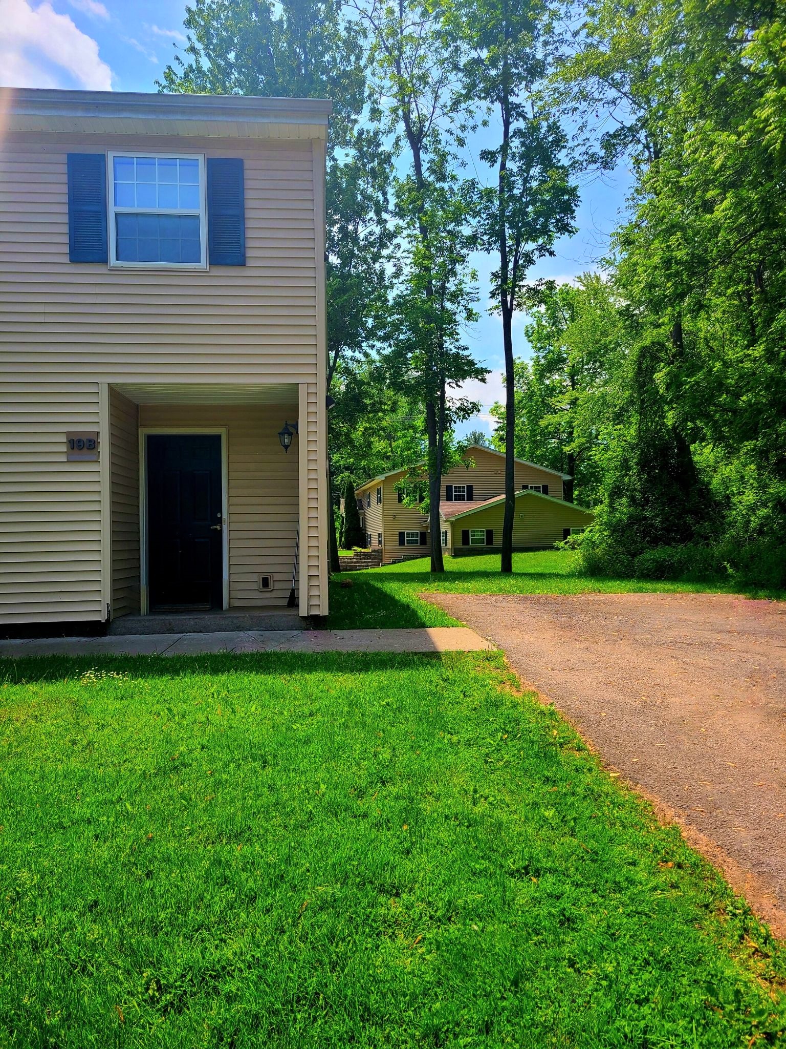 a house with a gravel driveway and a yard with grass