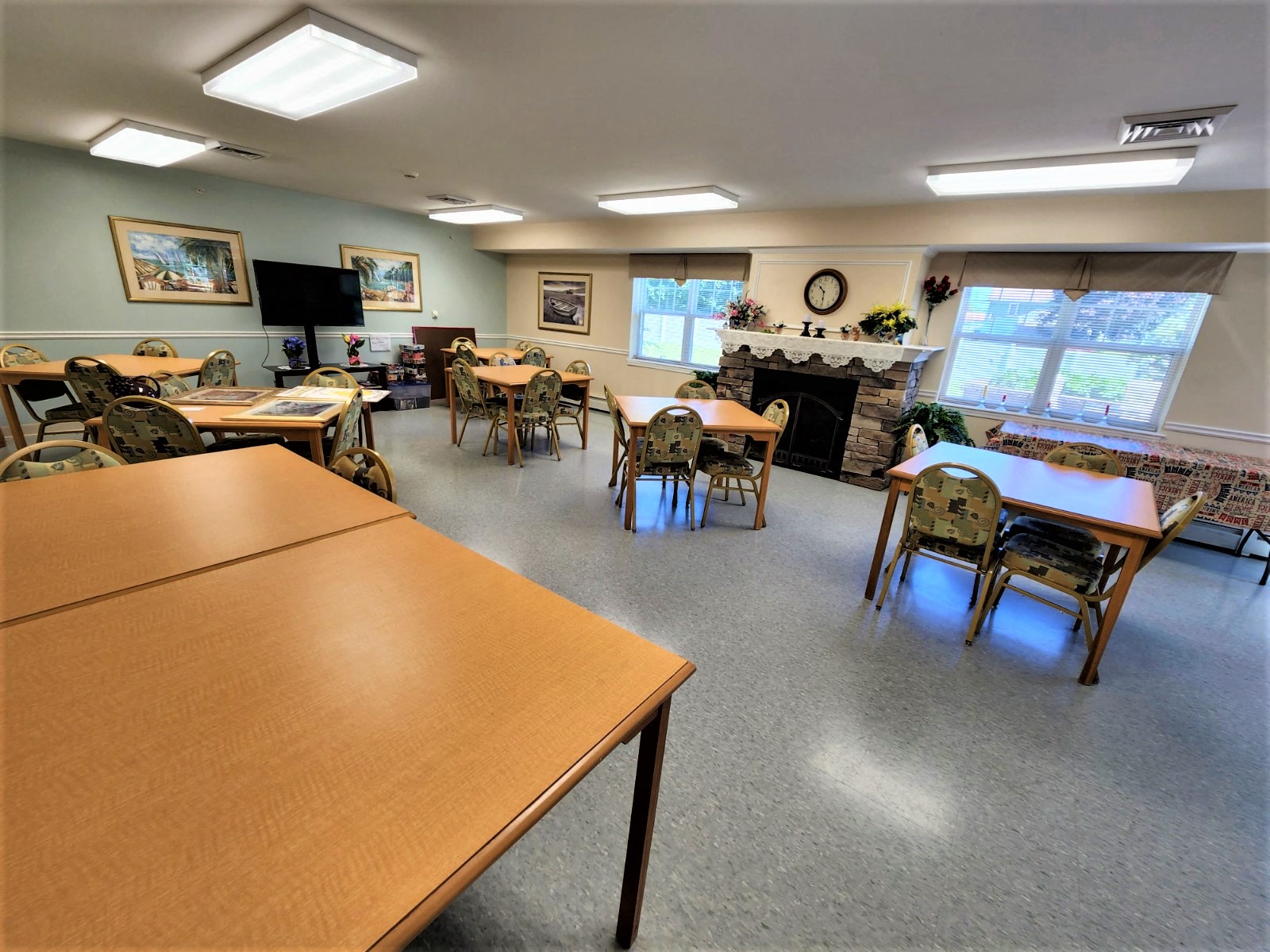 a dining room with tables and chairs and a fireplace