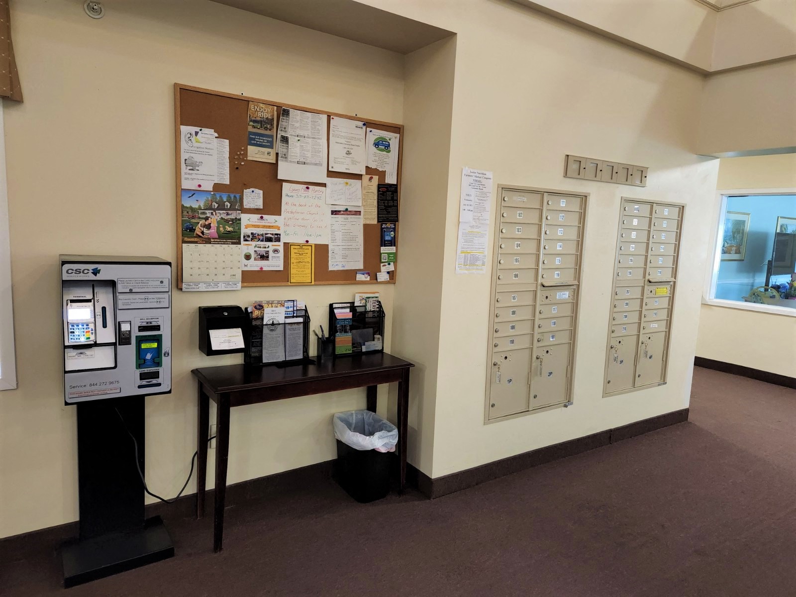 a vending machine in a room with papers on the wall