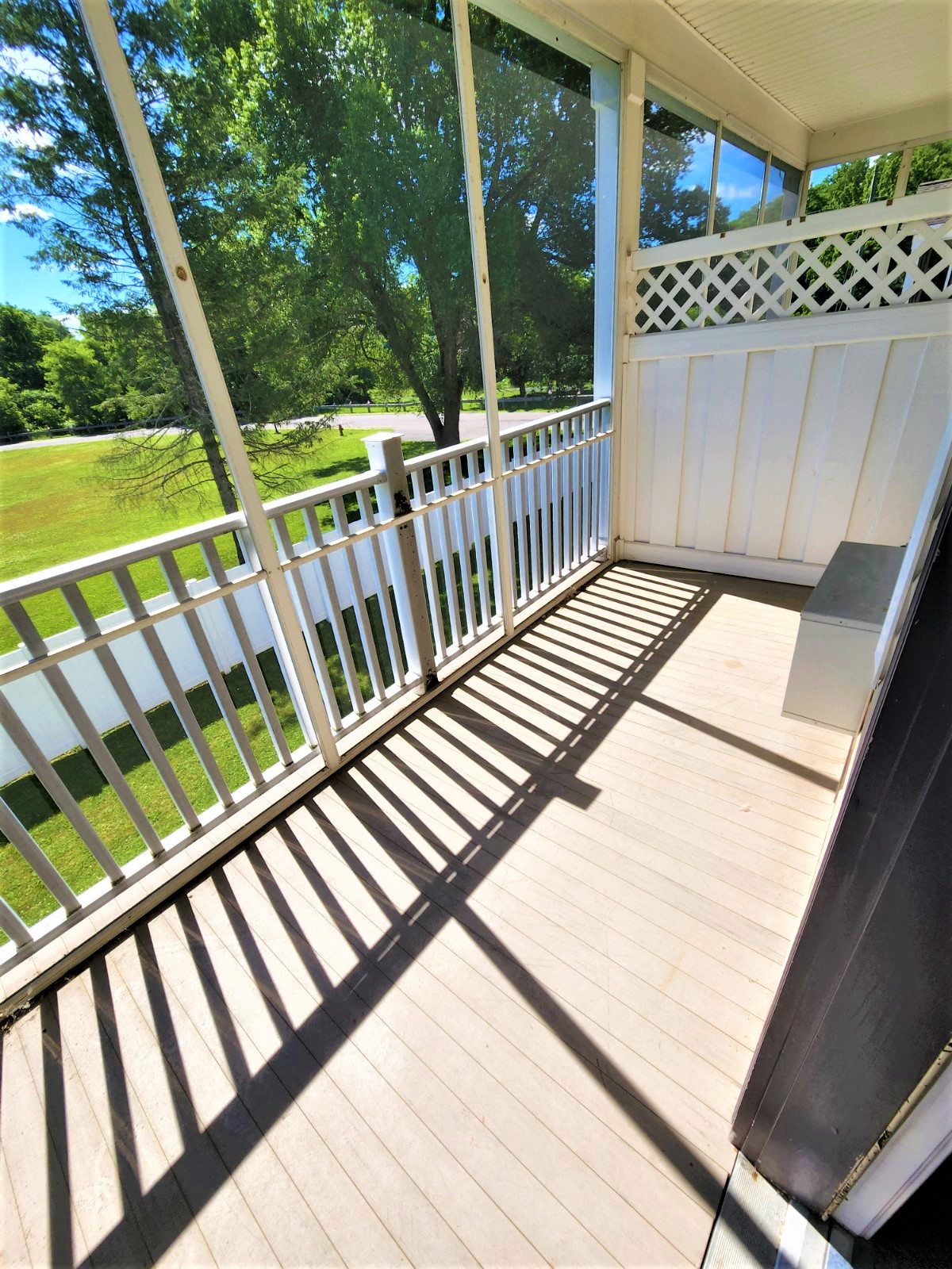 a view of the porch of a house with a porch swing