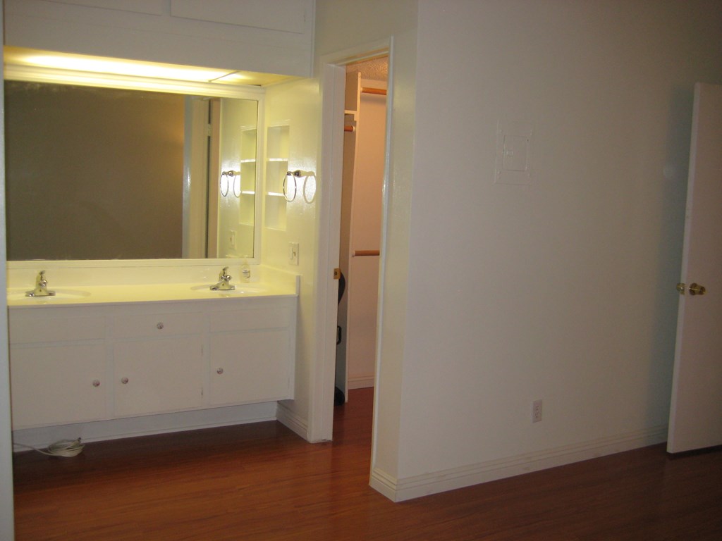 an empty bathroom with a sink and a mirror