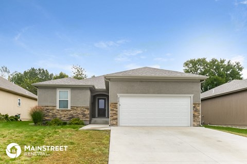 a beige house with a white garage door