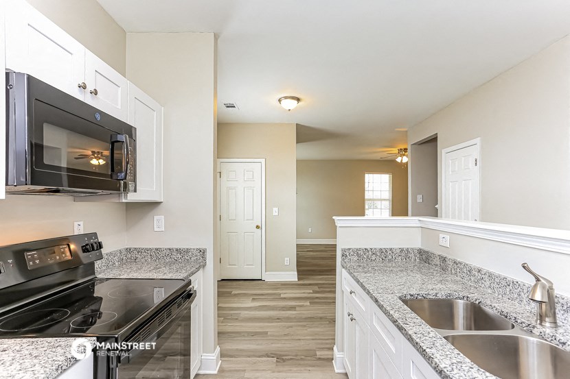 a kitchen with granite counter tops and a stove and microwave