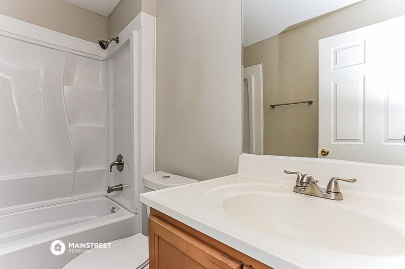 a bathroom with a sink and a shower and a toilet