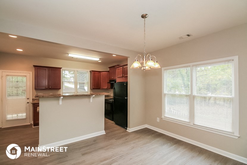 the kitchen is open to the dining room and living room