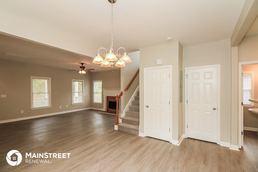the living room and dining room with stairs to the upper floors