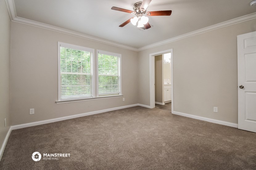 the master bedroom is spacious and has a ceiling fan