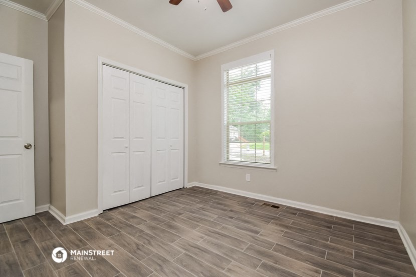 the living room of a home with a door and a window