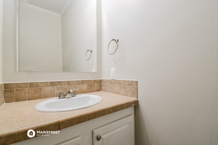 a small bathroom with a sink and a mirror