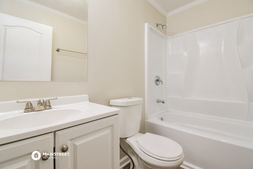 a white bathroom with a sink toilet and shower