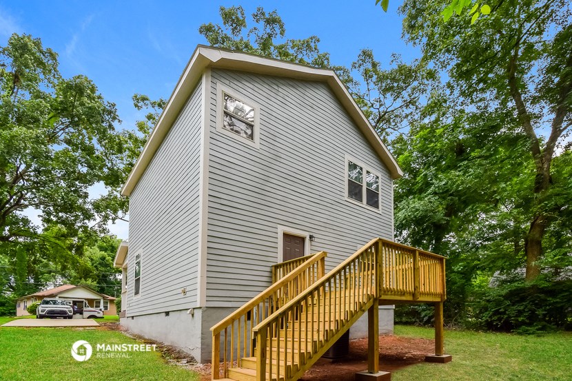 a house with a wooden porch and a wooden stairs