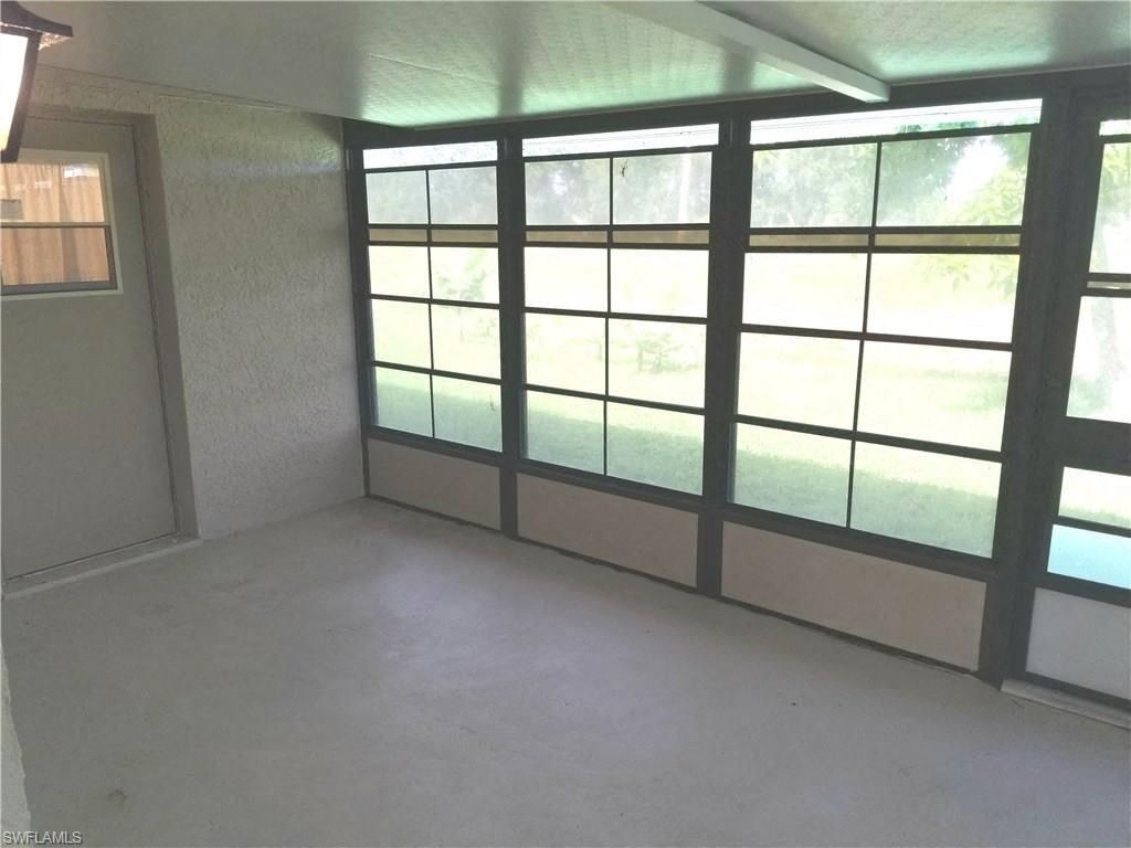 an empty living room with a large window
