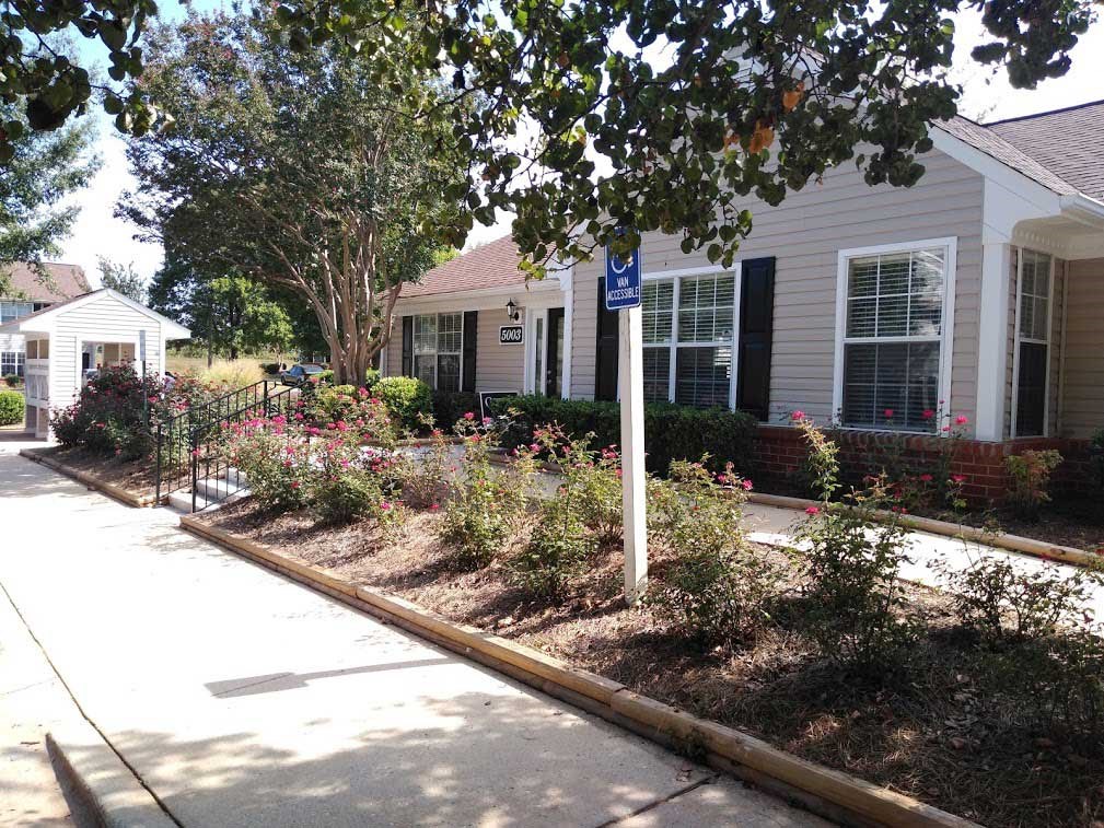a house with a flower garden in front of it