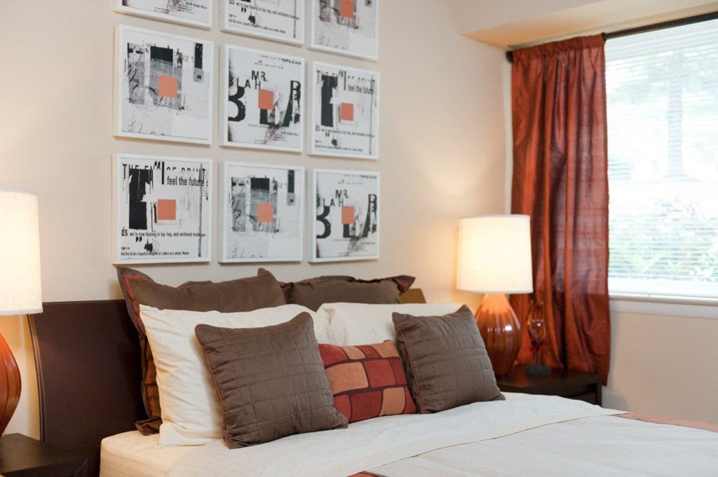 a bedroom with a bed and pictures on the wall above it